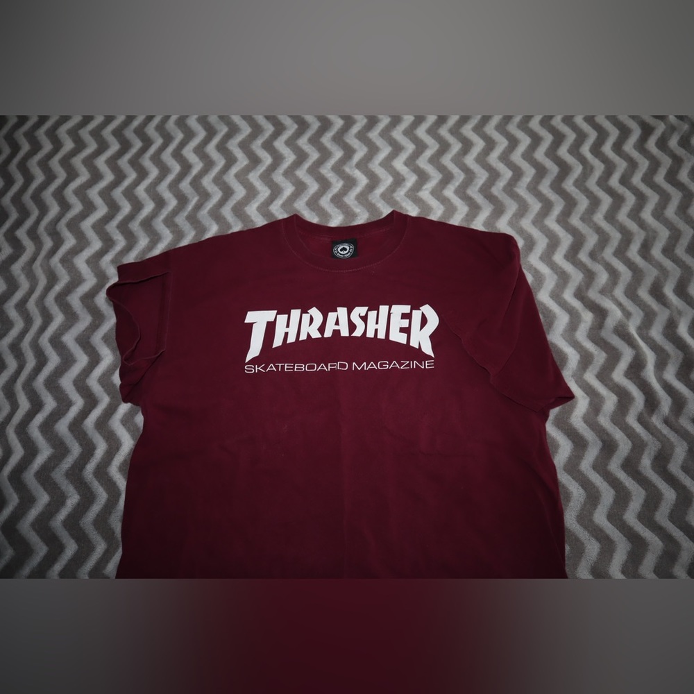 Thrasher tshirt. Some wear and tear. Possible bleach stain on back as pictured.